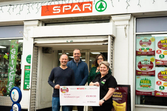 Keith Higgins collecting his prize from Tanya Rogers (Store Manager), Janet Bond (Area Manager) and Gareth James (Regional Manager) at SPAR Chirk.