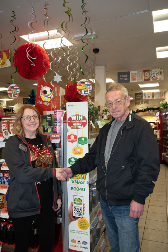 Chris Pilcher collecting his prize from Rachel Smith at SPAR Brumby Corner.